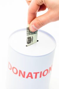 Hand donating money to charity