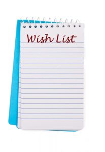 A notepad with wish list written on it isolated on a white background, christmas wish list