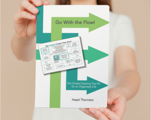 Woman holding and presenting a copy of Go With the Flow! 